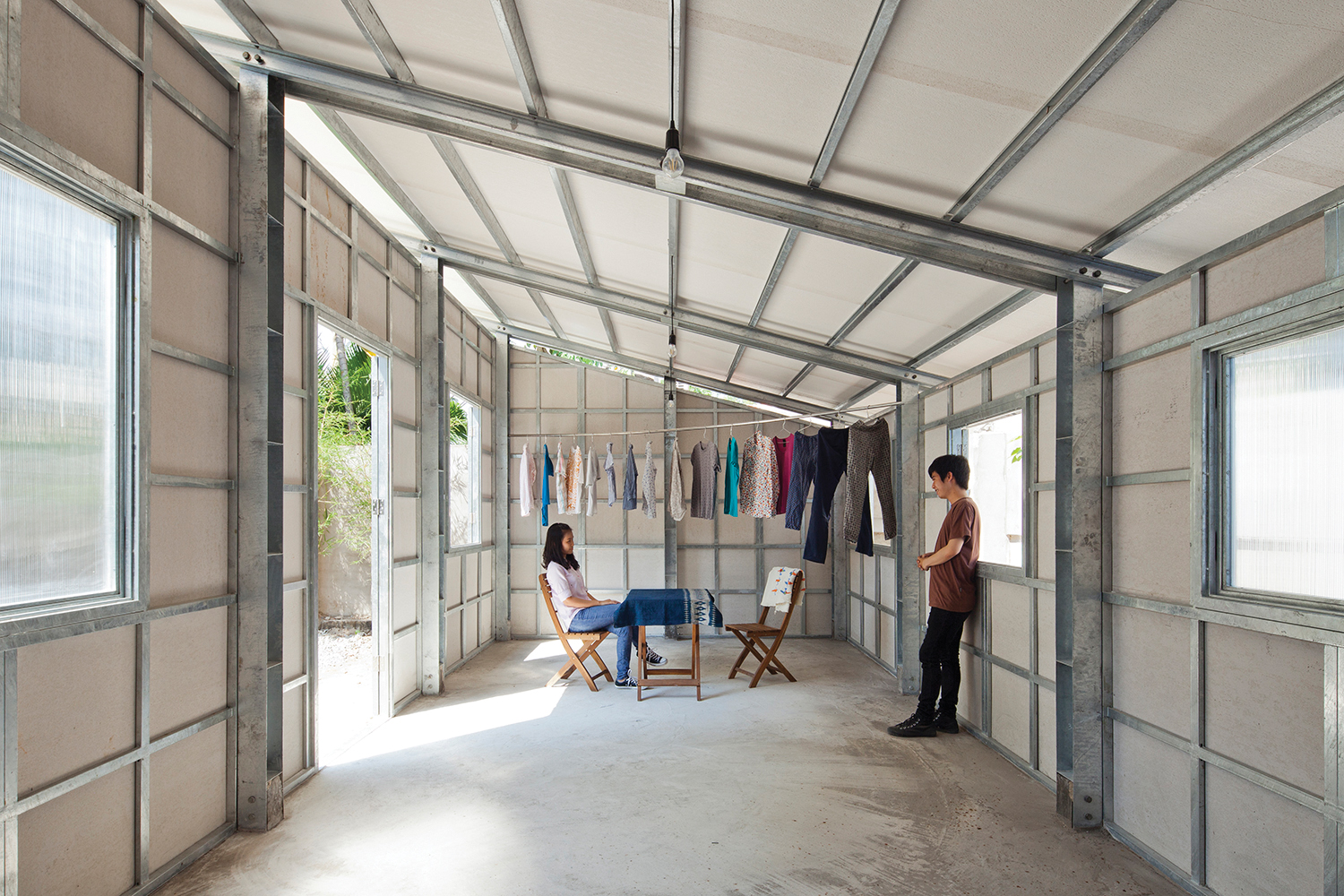 The third prototype combines the successful elements of the first and second prototypes and by adding a slender steel lattice to the lightweight steel frame, the rigidity of the house was increased allowing for a minimization of the quantity of steel required. Image © Vo Trong Nghia Architects