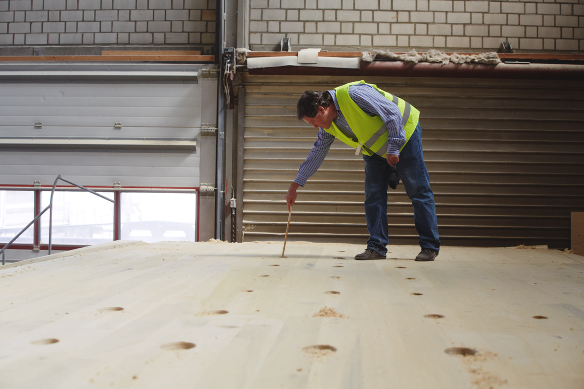  Cleaning dust from the perforations in the American tulipwood CLT panels. Image © AHEC, Photographer Jon Cardwell